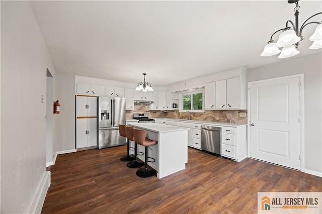 11 Amendola Dr, Netcong, NJ 07857 - kitchen with a chandelier, stainless steel appliances, light countertops, white cabinetry, and dark wood-type flooring