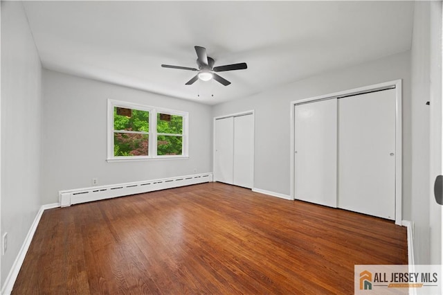11 Amendola Dr, Netcong, NJ 07857 - unfurnished bedroom with a baseboard heating unit, two closets, wood finished floors, baseboards, and a ceiling fan