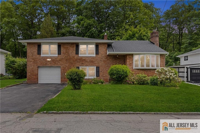 11 Amendola Dr, Netcong, NJ 07857 - tri-level home with asphalt driveway, a garage, a chimney, a front lawn, and brick siding