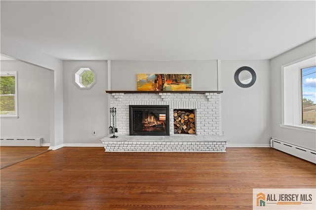 11 Amendola Dr, Netcong, NJ 07857 - unfurnished living room featuring baseboard heating, wood finished floors, and healthy amount of natural light