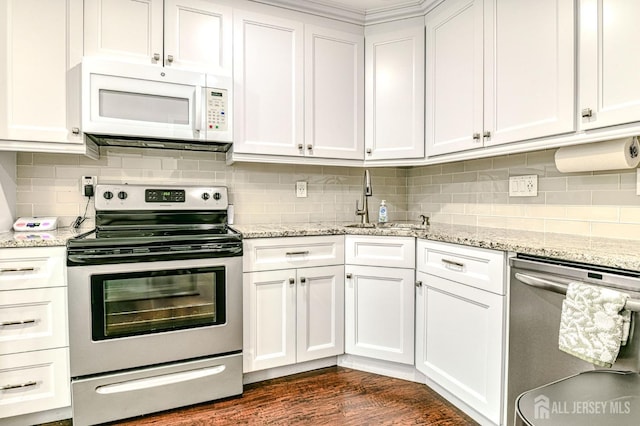 kitchen featuring stainless steel appliances, white cabinets, and decorative backsplash