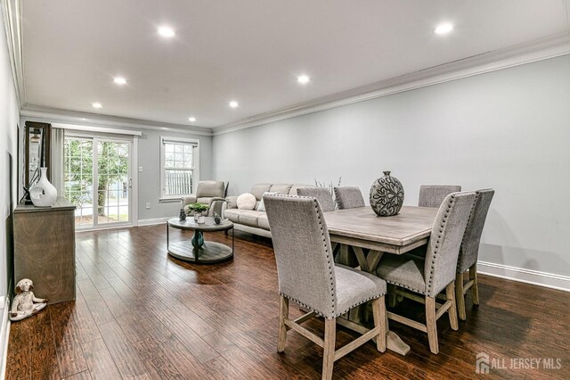 dining space with dark hardwood / wood-style flooring and ornamental molding