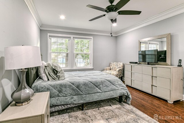 bedroom featuring ornamental molding, ceiling fan, and dark hardwood / wood-style flooring