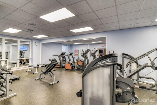 gym featuring a paneled ceiling