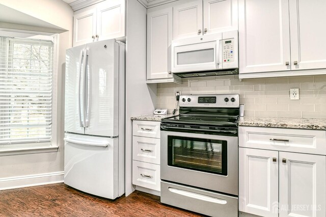 kitchen featuring white appliances, light stone counters, dark hardwood / wood-style flooring, and white cabinetry