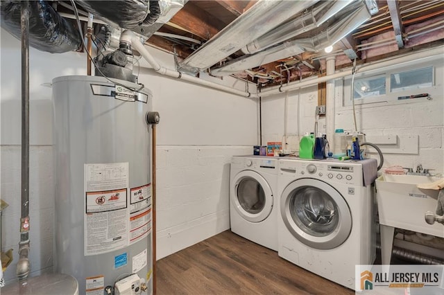 212 Freeman St, Woodbridge Proper, NJ 07095 - laundry area with water heater, washer and dryer, dark wood-style flooring, and concrete block wall