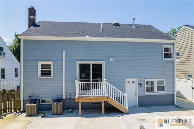 212 Freeman St, Woodbridge Proper, NJ 07095 - rear view of property with a chimney, roof with shingles, and a patio