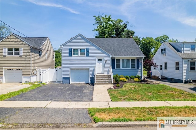 212 Freeman St, Woodbridge Proper, NJ 07095 - tri-level home with a gate, driveway, and an attached garage