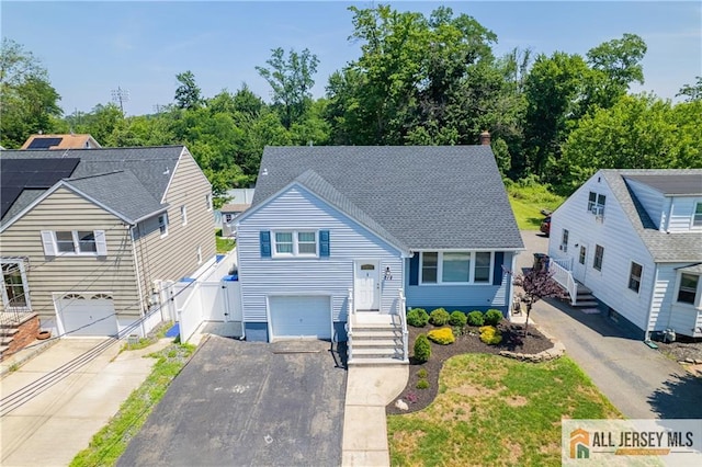 212 Freeman St, Woodbridge Proper, NJ 07095 - view of front of house featuring an attached garage, asphalt driveway, a gate, and a shingled roof