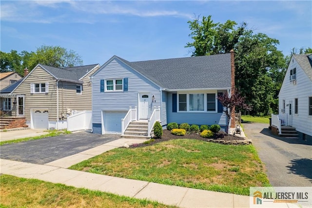 212 Freeman St, Woodbridge Proper, NJ 07095 - tri-level home featuring asphalt driveway, a garage, a chimney, a front yard, and a shingled roof
