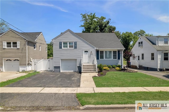 212 Freeman St, Woodbridge Proper, NJ 07095 - tri-level home with driveway, an attached garage, and a gate