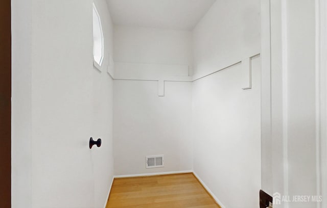 walk in closet with wood finished floors and visible vents