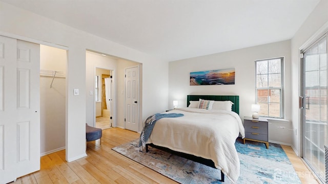 bedroom featuring light wood-type flooring and baseboards