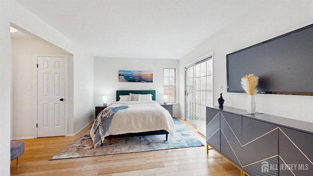 bedroom with baseboards and wood finished floors