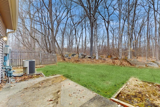 view of yard featuring cooling unit and fence