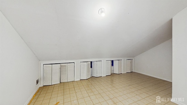 bonus room with visible vents, baseboards, and vaulted ceiling