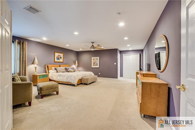 bedroom with light carpet, ceiling fan, and a closet