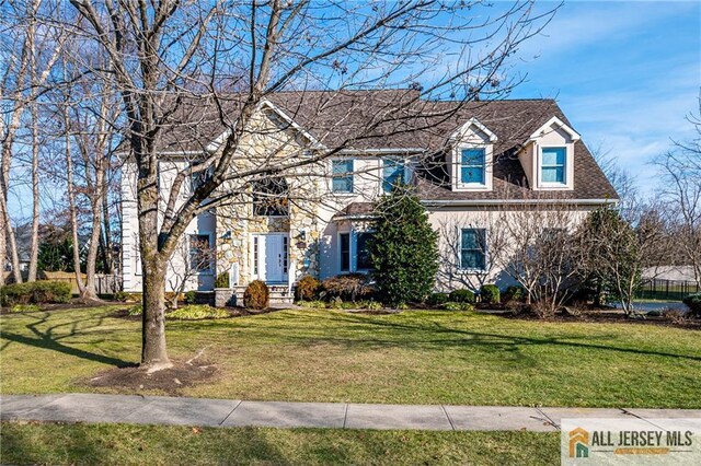 colonial inspired home with a front yard