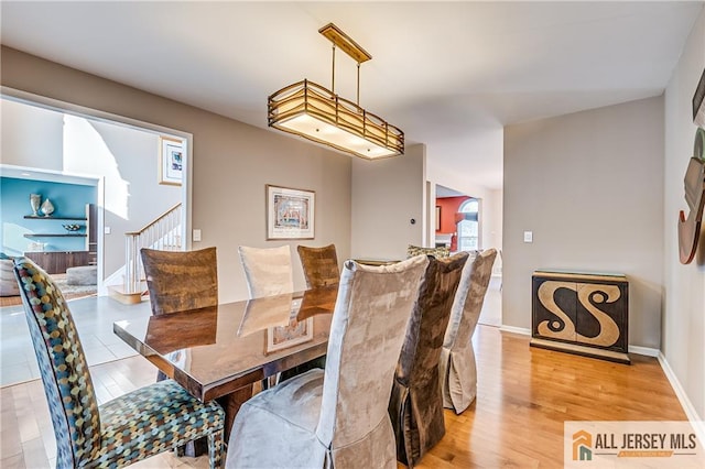 dining space with light hardwood / wood-style flooring