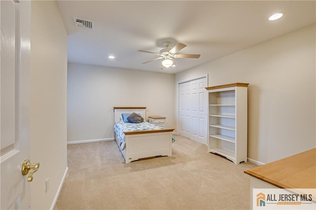 carpeted bedroom with ceiling fan and a closet