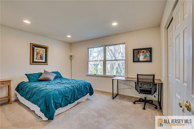 bedroom with light carpet and a closet