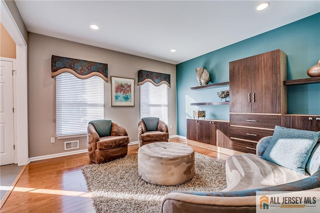 sitting room with hardwood / wood-style flooring