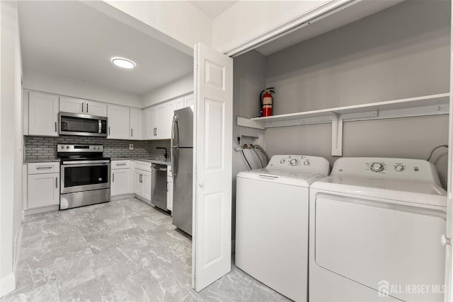 50 Ellen Heath Dr, Matawan, NJ 07747 - washroom featuring light marble finish flooring, washing machine and dryer, and a sink