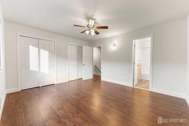 50 Ellen Heath Dr, Matawan, NJ 07747 - unfurnished bedroom featuring two closets, wood finished floors, baseboards, and connected bathroom