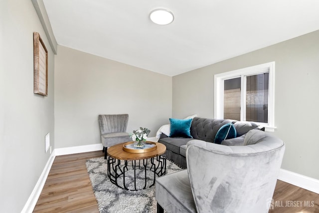 living room with baseboards and wood finished floors