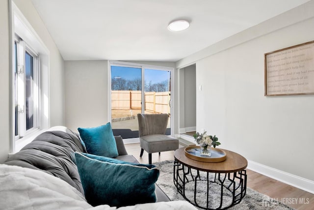 living room featuring wood finished floors and baseboards