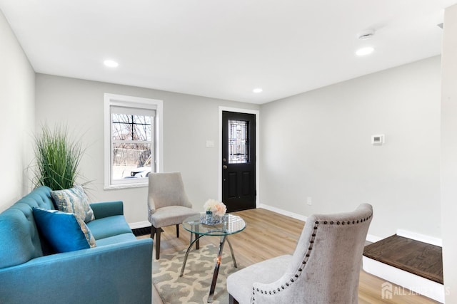 living area with light wood finished floors, recessed lighting, and baseboards