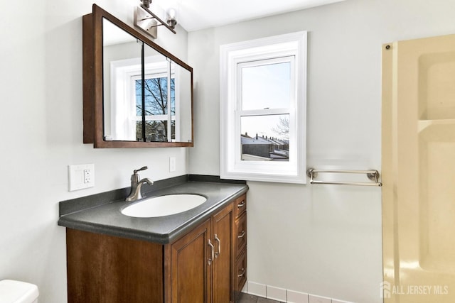 bathroom featuring vanity and toilet