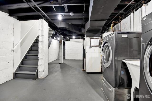 unfinished below grade area with stairway and washer / dryer