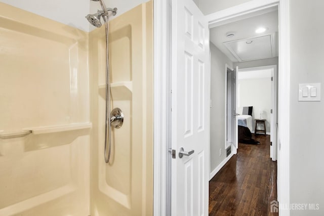 bathroom featuring a shower and wood finished floors