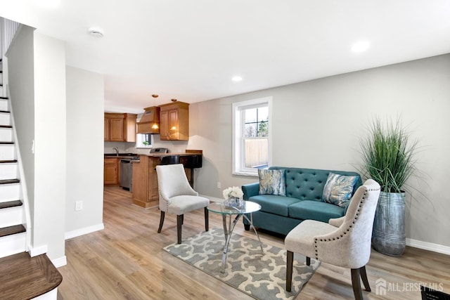 living area featuring stairway, recessed lighting, light wood-type flooring, and baseboards