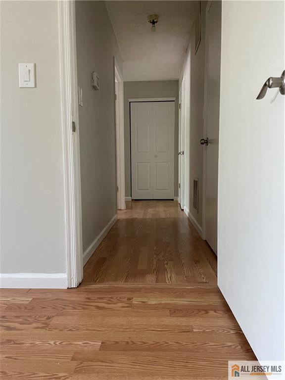 38 Brighton Way N, Brunswick, NJ 08902 - corridor featuring light wood finished floors and baseboards