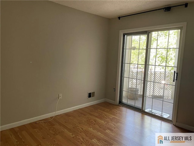 38 Brighton Way N, Brunswick, NJ 08902 - empty room with wood finished floors and a textured ceiling