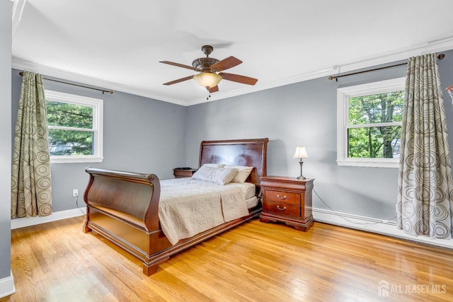 11 Eagle Rd, Edison, NJ 08820 - bedroom featuring multiple windows, light wood finished floors, crown molding, a ceiling fan, and a baseboard radiator
