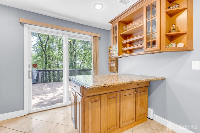 11 Eagle Rd, Edison, NJ 08820 - kitchen with open shelves, light tile patterned floors, light stone counters, brown cabinetry, and glass insert cabinets