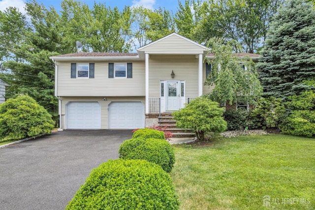 11 Eagle Rd, Edison, NJ 08820 - bi-level home with driveway, an attached garage, and a front yard