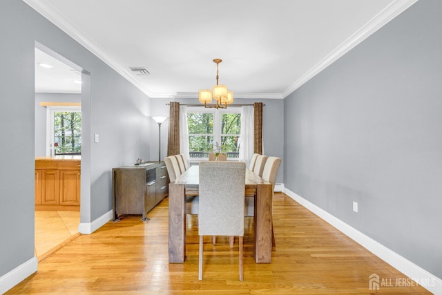 11 Eagle Rd, Edison, NJ 08820 - dining area with a chandelier, light wood-type flooring, and crown molding