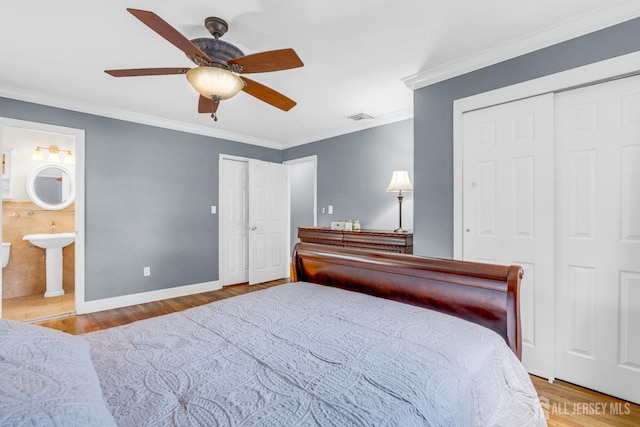 11 Eagle Rd, Edison, NJ 08820 - bedroom featuring wood finished floors, crown molding, ensuite bathroom, ceiling fan, and two closets