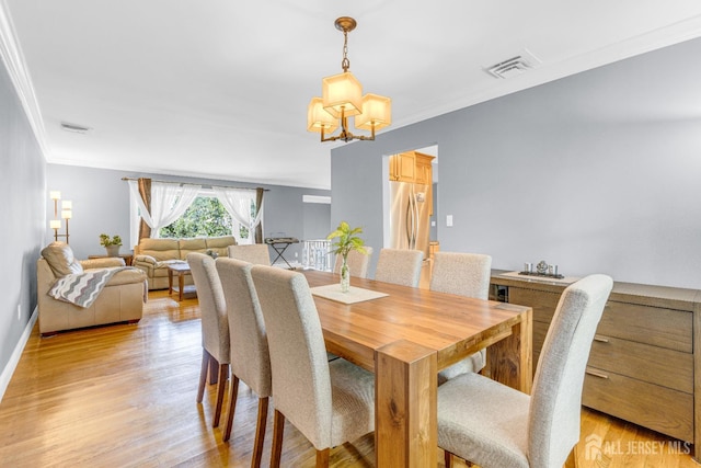 11 Eagle Rd, Edison, NJ 08820 - dining space featuring crown molding, a chandelier, and light wood-style flooring