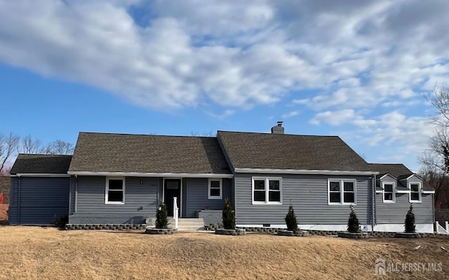 rear view of property featuring a chimney and roof with shingles