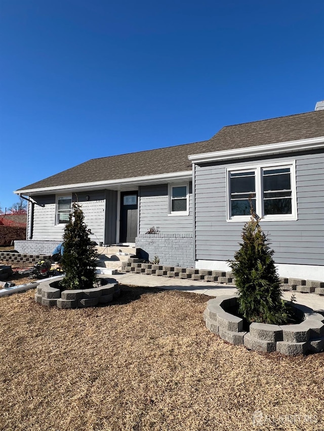 ranch-style house with roof with shingles