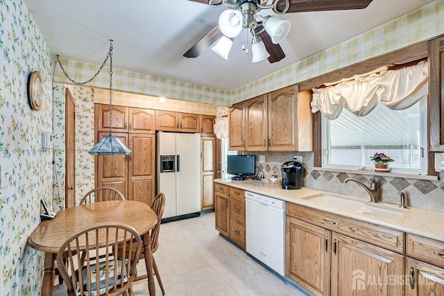 kitchen with sink, white appliances, and ceiling fan