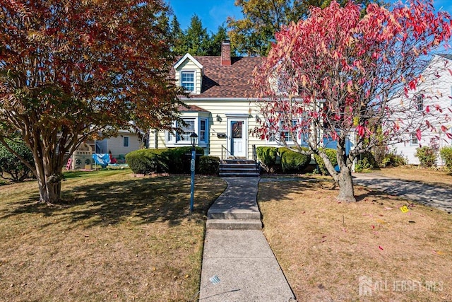 cape cod house with a front yard