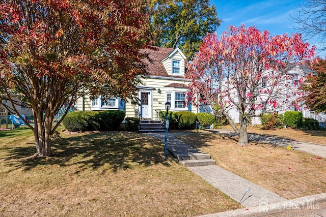 cape cod home with a front yard