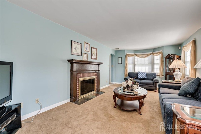 carpeted living room with a brick fireplace