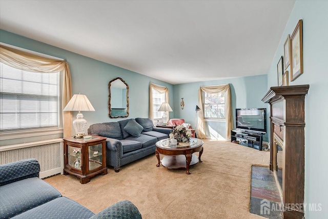 living room featuring light colored carpet and radiator heating unit